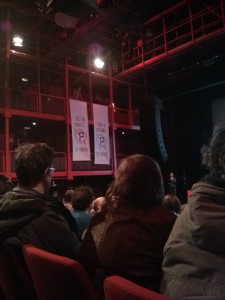 Photograph of protesters intervening at an evening discussion of mobility at the AB in Brussels by unfurling banners.
